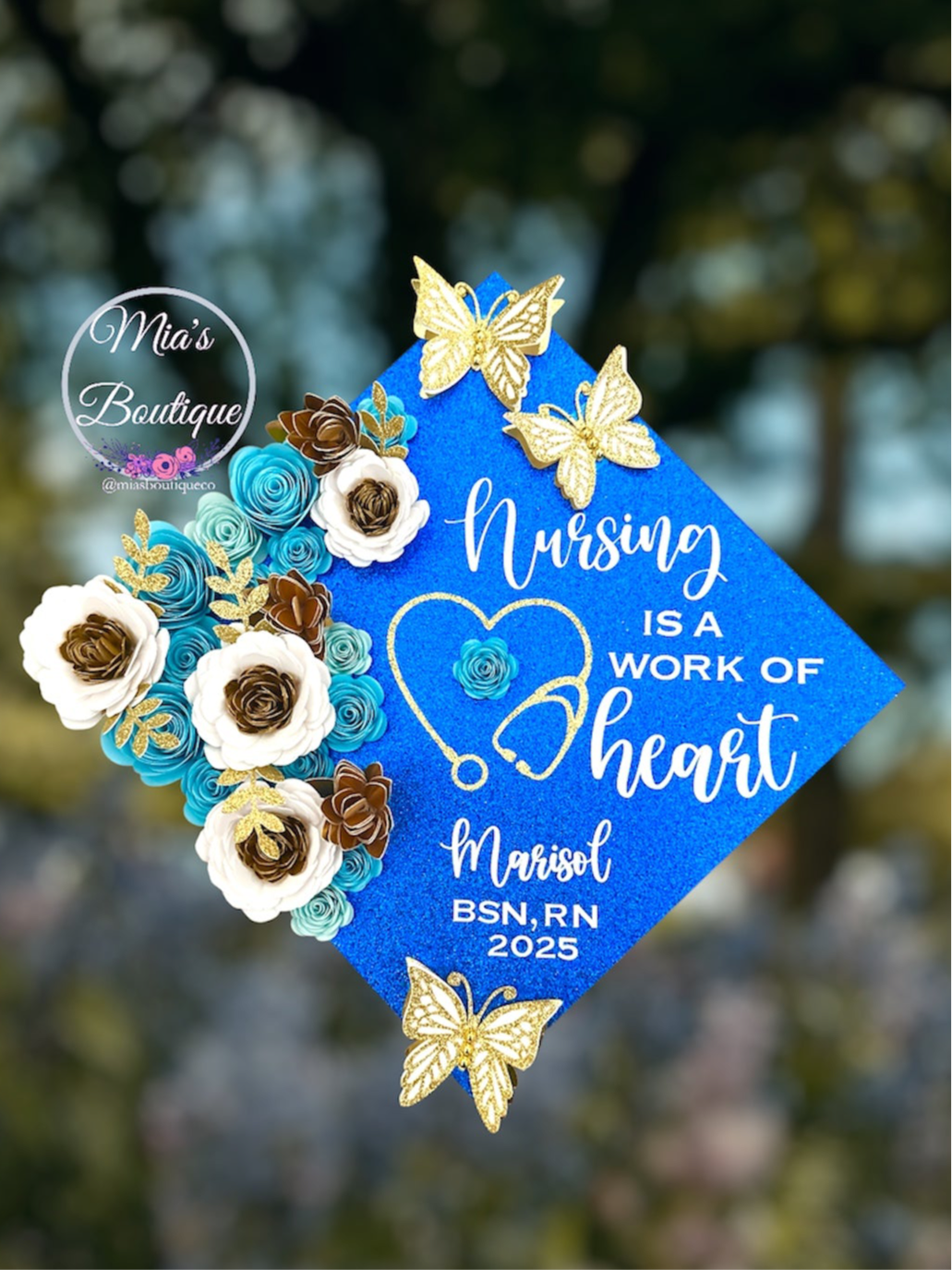 Custom Personalized Nurse Graduation Cap Topper Blue Heart Stethoscope with Nursing Is A Work Of Heart Message and Floral Sunflowers Blue White Gold Flowers Gold Butterfly